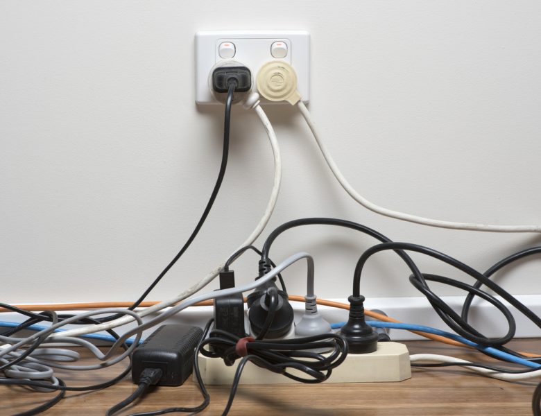 Overcrowded power board in home office