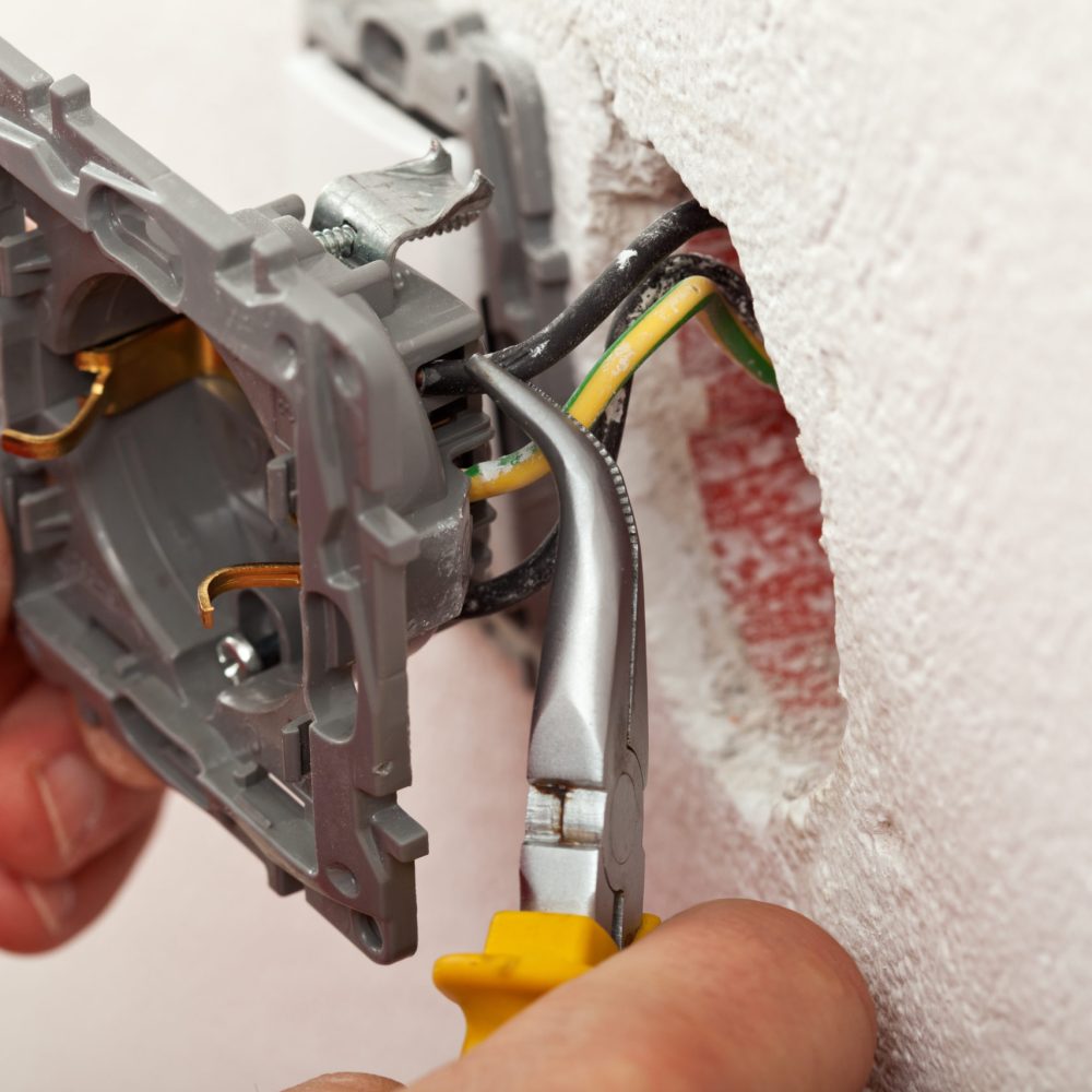 bigstock-Electrician-Hands-Installing-W-64469248-scaled